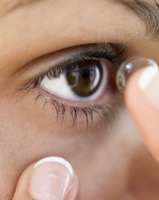 Woman putting on contacts