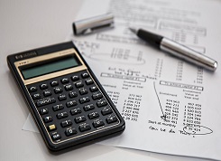 Calculator and pen on table